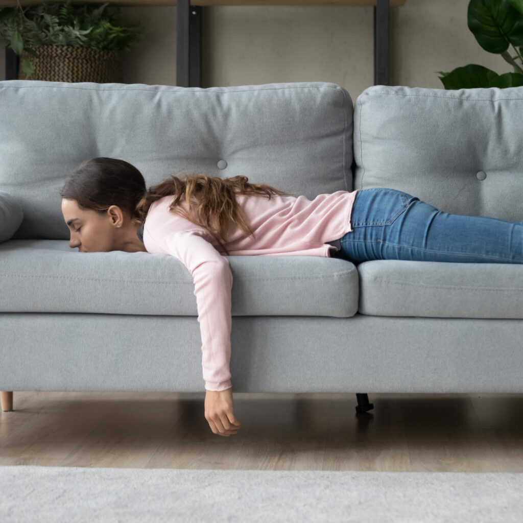 Full,Length,Of,Girl,Lying,Rest,At,Home,In,Living
